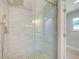 Modern glass shower with river rock flooring and brushed nickel fixtures at 6432 Boatyard Dr, Hudson, FL 34667
