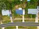 Aerial view of a property with a nice roof in a tranquil neighborhood with mature landscaping at 7365 Pinehurst Dr, Spring Hill, FL 34606