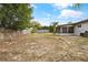 The house has a partially fenced yard with space for outdoor living at 7365 Pinehurst Dr, Spring Hill, FL 34606