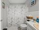 Bathroom featuring a Paris-themed shower curtain, tiled floor, and a single sink at 7365 Pinehurst Dr, Spring Hill, FL 34606