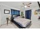 Relaxing bedroom boasts neutral colors, tile floor, and decorative dark blue curtains at 7365 Pinehurst Dr, Spring Hill, FL 34606