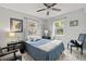 Bright bedroom features cool tones, natural light, a ceiling fan, and two windows at 7365 Pinehurst Dr, Spring Hill, FL 34606