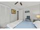 A brightly lit bedroom with closet, light blue accents, and neutral colors at 7365 Pinehurst Dr, Spring Hill, FL 34606