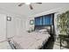 Primary bedroom with tile floor, modern ceiling fan, and minimalist decor at 7365 Pinehurst Dr, Spring Hill, FL 34606