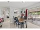 Bright dining area featuring a wooden table, modern chairs, and sliding glass doors to the patio at 7365 Pinehurst Dr, Spring Hill, FL 34606