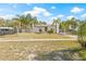 Inviting single-Gathering home with a tidy front yard, mature palm trees, and a neatly paved walkway leading to the entrance at 7365 Pinehurst Dr, Spring Hill, FL 34606