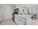 Cozy kitchen featuring white cabinets, marble countertops, and open layout, and black appliances at 7365 Pinehurst Dr, Spring Hill, FL 34606