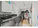 Laundry room with appliances, storage, and organization at 7365 Pinehurst Dr, Spring Hill, FL 34606