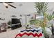 Open-concept living room featuring tile floors, neutral paint, and a large television at 7365 Pinehurst Dr, Spring Hill, FL 34606