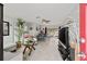 Bright living room featuring tile floors, neutral decor, and open access to the dining area at 7365 Pinehurst Dr, Spring Hill, FL 34606