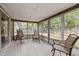 A sun room with chair setting and natural lighting at 7365 Pinehurst Dr, Spring Hill, FL 34606