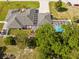 Overhead view of a home featuring a screened pool, well-maintained landscaping, and a durable, patterned roof at 7466 Jonquil Pl, Weeki Wachee, FL 34607