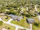 Expansive aerial view showcasing a home with a screened-in pool and lush landscaping in a serene neighborhood setting at 7466 Jonquil Pl, Weeki Wachee, FL 34607