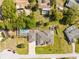 Wide aerial view of the home with a pool and a guest house, nestled among mature trees and lush landscaping at 7466 Jonquil Pl, Weeki Wachee, FL 34607