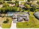 Beautiful aerial view featuring a main home, a guest house, a screened in pool, and a large driveway at 7466 Jonquil Pl, Weeki Wachee, FL 34607