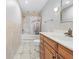 Full bathroom with tile surround, vanity, and shower/tub combo with bronze fixtures at 7466 Jonquil Pl, Weeki Wachee, FL 34607