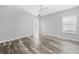 Bright bedroom with wood-look floors, neutral walls, ceiling fan, and natural light from a window at 7466 Jonquil Pl, Weeki Wachee, FL 34607