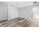 Bright bedroom with wood-look floors, neutral walls, ceiling fan, closet, and ensuite bathroom at 7466 Jonquil Pl, Weeki Wachee, FL 34607
