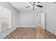 Bedroom featuring wood-look floors, neutral walls, a large window, and a ceiling fan at 7466 Jonquil Pl, Weeki Wachee, FL 34607