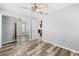 Bedroom with wood-look floors, closet, neutral walls, and ensuite bathroom at 7466 Jonquil Pl, Weeki Wachee, FL 34607