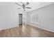 Bedroom with wood-look floors, neutral walls, ceiling fan, and mirrored closet at 7466 Jonquil Pl, Weeki Wachee, FL 34607