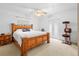 Bright bedroom with a decorative wood bed frame and access to the outdoors at 7466 Jonquil Pl, Weeki Wachee, FL 34607