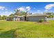 Well-kept single-story home with a large front lawn and tropical landscaping providing great curb appeal at 7466 Jonquil Pl, Weeki Wachee, FL 34607