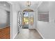 Bright foyer with decorative glass front door, tile floor, and view to the front yard at 7466 Jonquil Pl, Weeki Wachee, FL 34607