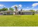 Charming single-story home featuring a well-manicured lawn, double-door entryway, and tasteful landscaping at 7466 Jonquil Pl, Weeki Wachee, FL 34607