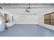 Spacious, clean garage featuring epoxy flooring, a ceiling fan, and ample room for vehicles and storage at 7466 Jonquil Pl, Weeki Wachee, FL 34607