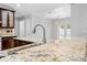 An open kitchen with granite countertops and a stainless steel faucet at 7466 Jonquil Pl, Weeki Wachee, FL 34607