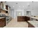 A well-lit kitchen featuring stainless steel appliances and ample countertop space at 7466 Jonquil Pl, Weeki Wachee, FL 34607