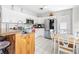 Bright kitchen with white cabinetry, stainless steel appliances, and an attached island with countertop seating at 7466 Jonquil Pl, Weeki Wachee, FL 34607