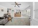 Open concept living area with bar seating, white kitchen, and natural light streaming in through the windows at 7466 Jonquil Pl, Weeki Wachee, FL 34607