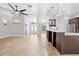 Living room with tile floors open to kitchen, featuring a kitchen bar, pendant lighting, and stainless steel appliances at 7466 Jonquil Pl, Weeki Wachee, FL 34607