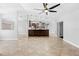 Bright living area with tile floors open to kitchen, featuring a large kitchen bar and modern pendant lighting at 7466 Jonquil Pl, Weeki Wachee, FL 34607