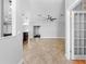 Open-concept living room featuring tile floors, ceiling fan, and view of kitchen and dining area at 7466 Jonquil Pl, Weeki Wachee, FL 34607