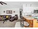 Inviting living area flowing into a kitchen with breakfast bar and white cabinets at 7466 Jonquil Pl, Weeki Wachee, FL 34607