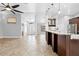 Spacious living room with tile floors open to kitchen, featuring a kitchen bar, pendant lighting at 7466 Jonquil Pl, Weeki Wachee, FL 34607