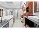 Bathroom with granite countertops, soaking tub, and a vanity with dual sinks at 7466 Jonquil Pl, Weeki Wachee, FL 34607
