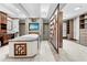 Luxurious bathroom with a soaking tub, television, and unique decorative wood and frosted glass door to the closet at 7466 Jonquil Pl, Weeki Wachee, FL 34607