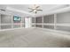 Bedroom with carpet and television mounted on the decorative wall with white trim at 7466 Jonquil Pl, Weeki Wachee, FL 34607