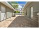 Large brick patio with a screened ceiling connects to the house with AC unit, doors, and an attached pool at 7466 Jonquil Pl, Weeki Wachee, FL 34607