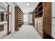 A large walk-in closet has built in shelving and drawers and decorative frosted glass at 7466 Jonquil Pl, Weeki Wachee, FL 34607