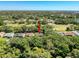 Aerial shot showcases the property nestled within lush greenery in a quiet neighborhood at 7700 Fairlawn Dr, Hudson, FL 34667