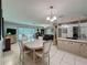 Open dining area with tile floors connects seamlessly to the living room, creating an inviting atmosphere at 7700 Fairlawn Dr, Hudson, FL 34667