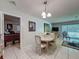 The dining area features a table with four chairs, is adjacent to the living room, and provides access to the bedroom at 7700 Fairlawn Dr, Hudson, FL 34667