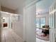 Hallway leading to a bathroom, and a living room with access to the backyard at 7700 Fairlawn Dr, Hudson, FL 34667