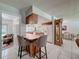 Open-concept kitchen with breakfast bar, tile flooring, and views of the dining area at 7700 Fairlawn Dr, Hudson, FL 34667