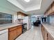 This is a bright kitchen that features wood cabinets, a breakfast bar, and stainless steel appliances at 7700 Fairlawn Dr, Hudson, FL 34667